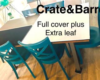 Long farmtable with padded cover plus extra leaf. 6 chairs included