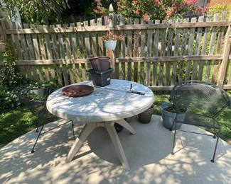 Patio table and wrought iron chair.
