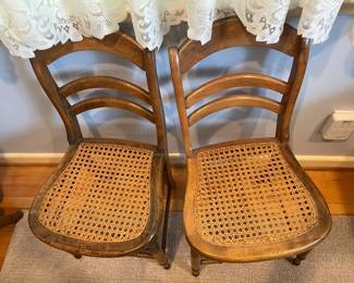 Pair of Victorian Eastlake style ladderback cane dining chairs.