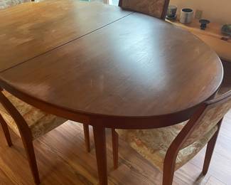 Teak table with two leaves.