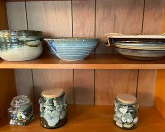 Jars with stones and marbles, plus pottery bowls.