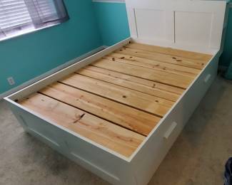 Queen bed with under-bed and headboard storage. Like new condition.