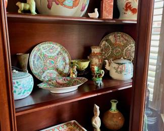 China cabinet filled with antique treasures including two Chinese Foo dog ginger jars, Foo dog carving out of Soushan stone, Chinese Rose Medallion Vase as well as Vintage Chines teapot circa 1850