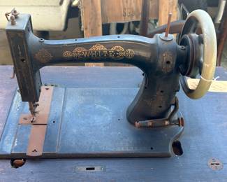 Antique White sewing machine with cabinet.