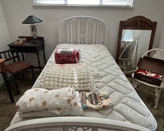 Antique bed with plush twin mattress.