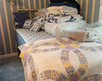 Linens inc quilts.   2 Twin mattresses  and box springs.  2 brass twin beds