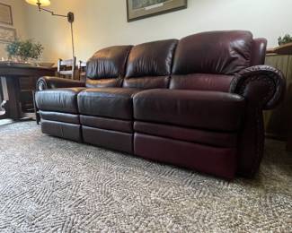 Very comfortable 3 cushion leather sofa with reclining end seats.