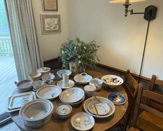 Round oak pedestal table with a great collection of pottery