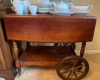 Set of white dishes and serving cart with drawer
