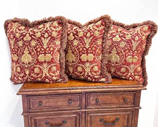A set of 3 red and gold sofa pillows with down fill inserts