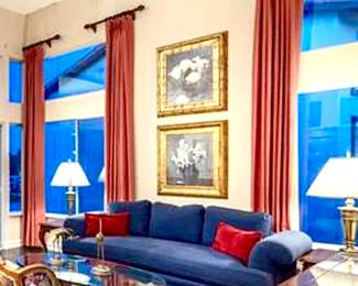 Vintage Marge Carson Navy Blue Sofa with solid down filled continuous cushion. 2 brass Stiffel Lamps