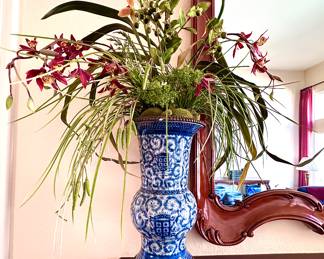 A pair of blue and white porcelain arrangements with faux orchids and lilies from Jonathan’s Coastal Living.  