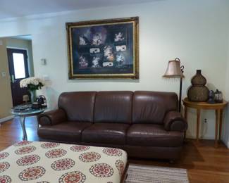 Pair of leather sofas, side tables, framed art