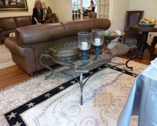 Coffee table with glass top & pewter colored metal frame, bric-a-brac, area rug