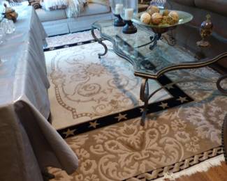 Coffee table with glass top & pewter colored metal frame, bric-a-brac, area rug