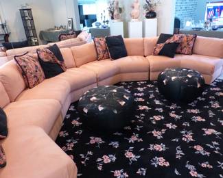 Circular sectional sofa, accent pillows, ottoman poufs, area rug
