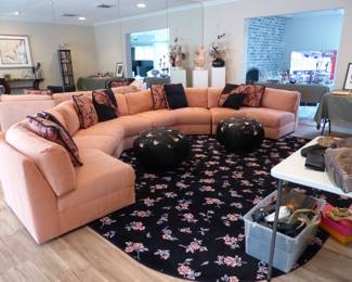 Circular sectional sofa, accent pillows, ottoman poufs, area rug