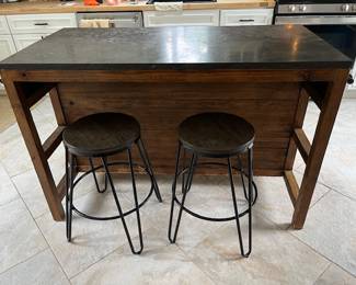 Crate and Barrel kitchen Island with bluestone top and stools. Shelf storage on opposite side.