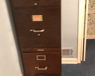 Stacked metal wood look filing cabinet(s). It is in laundry room.