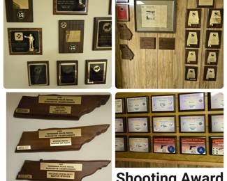 The basement den walls are covered with Shooting award plaques. Owner is downsizing - keeping guns but parting with the awards.