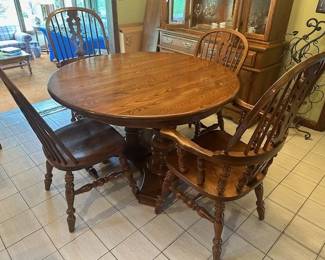 Nichols and Stone oak kitchen table and six chair set. Table measures 48" round with 4 12" leaves and pads included