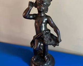 Bronze cherub holding a basket of flowers