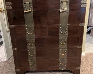 Chinese Tonsu styleElmwood Engraved brass-bound six drawer wedding chest; CA. 1930; the high chest fitted with six blind drawers brass bound with heavy clasp hinges and bail handles on terraced bracket feet