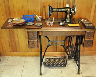 Antique Singer sewing machine - it is from around 1910. It has many accessories and books. Also in Quarter sawn oak. It is not electric but power by the treadle that you operate.