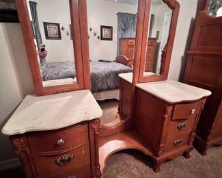 Vanity with marbled countertops and full length mirror