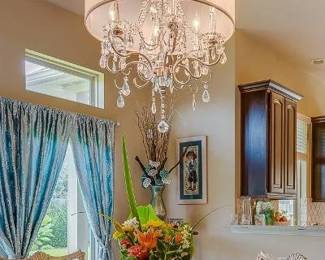 Crystal chandelier with linen drum; light blue curtains for 3 windows, Erté dinnerware, Lenox Legend crystal stemware
