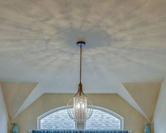 small chandelier with crystal beads displaying a beautiful pattern of light