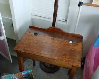 Antique child's school desk with storage under writing area