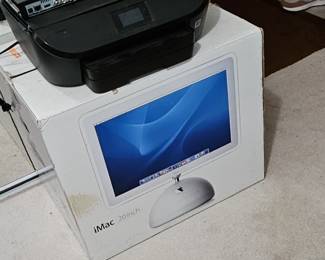 iMac computer, in the box with keyboard, speakers, and other accessories. 