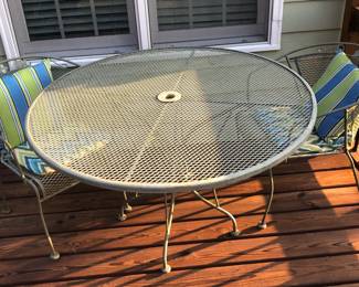 Outdoor wrought iron table and two chairs with cushions