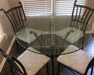 Beveled glass top kitchen table with four padded chairs