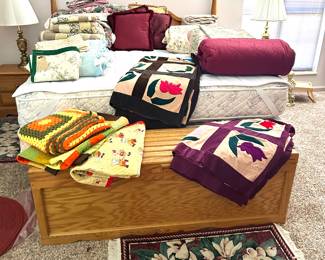 several handmade quilts and quilt tops