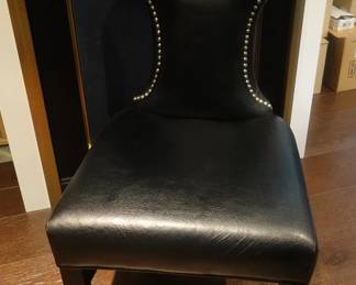 )NE OF TEN BLACK LEATHER DINING CHAIRS