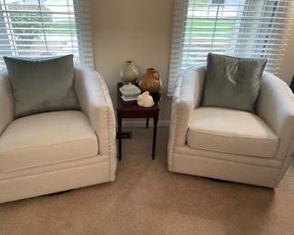 Pair of swivel barrel chairs by Tommy Hilfiger