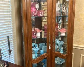 China cabinet filled with vintage Fenton and Mary Gregory selections