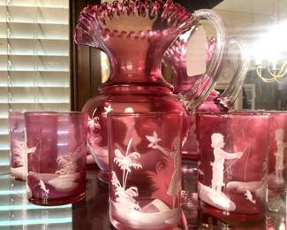Vintage cranberry Mary Gregory pitcher and 6 glasses;
