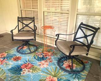 Two matching swivel chairs; colorful rug