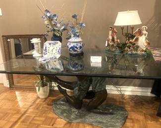 Glass top dining table with sculptured base