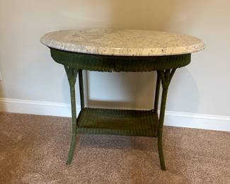 P52 - $30. Side Table Marble and wicker base. Measures 33.5" wide x 21" deep x 30" tall. (Marble is in great condition - wicker is aged with a lot of wear.)