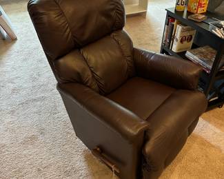 P51 - $150. 2017 La-Z Boy rocking recliner faux leather. Has some ware on head rest. Measures 26" wide x 33" deep x 39" tall