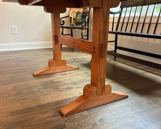 P4 - $400. Solid Wood Trestle style dining table. Has stain on the top but it's in the finish not the wood - wood is *not* warped.  Measures 48" wide x 34" deep  x 30.5" tall. 2 leaves slide into the ends and add 24" total (12" each leaf). Quality Construction! Beautiful piece - easy refinish project. 