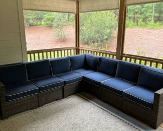 P36 - $1750. Frontgate Palermo Collection. 7 piece wicker modular sectional. Measures 103" wide (each side) x 31" deep x 32" tall. Overall in excellent condition! (One cushion has a stain but it comes with 2 replacement cushions.) Moves in 7 pieces. 