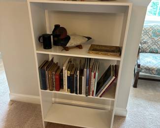 P49 - $20. White wooden bookcase. Measures 31" wide x 11.5" deep x 55.5" tall