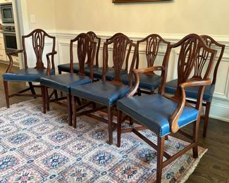 P12 - $350 Set. Set of 8 Mahogany Hepplewhite Style Dining Chairs.  Seats are blue leather. 6 side chairs: Measure 21" wide x 18.5" deep  x 39" tall. 2 arm chairs: Measure 22" wide x 18.5" deep  x 39" tall. **One captains chair has a cracked piece on the back - would need repair for regular use. 