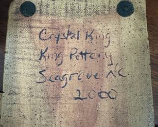 P112 - $30. Crystal King Folk Art Pottery Dog. Has separated from stand. 