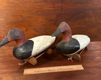 P97 - $150 Each. 2 Available (multiple photos to show angles) Unsigned Canvasback Duck Decoys. Carved wood with some age on them! Great paint. Overall very good vintage condition. One has crack around the neck area. Both have metal rings on the bottom and come with photographed stands. 